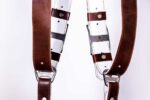 Close-up of Brown Vintage White Padding harness shoulders showing dual brown leather straps with white stitch detailing, white padded interior, and brown leather accent bands with metal hardware connectors