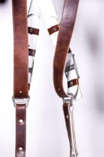 Close-up of Brown Vintage White Padding harness center X-intersection showing white padding with brown leather accent bands crossing, metal hardware, rivets, and stitched edges