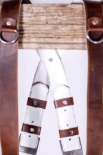 Overhead view of Brown Vintage White Padding leather camera harness displaying complete X-design with brown shoulder straps, metal D-rings, white padded center strap with brown leather accent patches arranged symmetrically