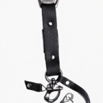 Close-up of black leather camera strap end with silver clasp and rivet details on a light background.
