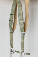 Close-up of both strap ends of the Green Marble leather camera harness, showing the mottled sage-green marbled leather with silver square buckles, green leather keeper loops, cream leather backing, branded triangular D-ring connectors, silver rivets, and marine-grade snap hooks with green leather safety tabs.