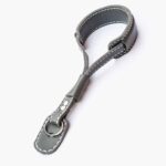 Full view of a grey leather wrist strap with metal hook clasp