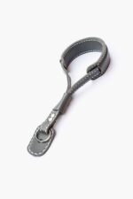 Full view of a grey leather wrist strap with metal hook clasp