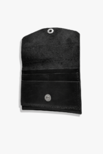 Open black leather battery and SD card holder with multiple card slots, snap closure, and suede interior on a light gray background.