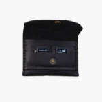 Dark brown leather battery and SD card holder opened to show storage slots with memory cards inside on a light gray background.
