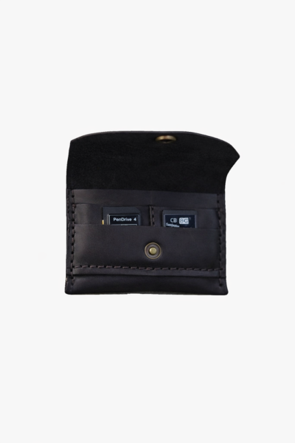 Dark brown leather battery and SD card holder opened to show storage slots with memory cards inside on a light gray background.