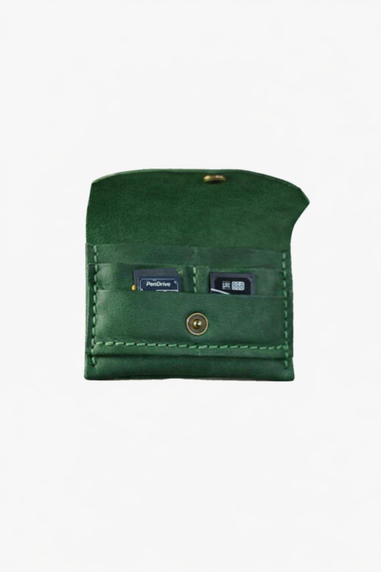 Green leather battery and SD card holder opened to show storage slots with memory cards inside on a light gray background.
