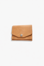Light brown leather battery and SD card holder pouch with snap button closure and stitched edges on a light gray background.