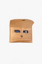 Light brown leather battery and SD card holder opened to show storage slots with memory cards inside on a light gray background.