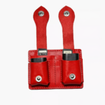 Red leather dual battery holder with two hanging tabs on a light background.