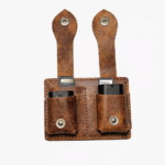 Brown leather dual battery holder with two hanging tabs on a light background.