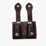 Dark brown leather dual battery holder with two hanging tabs on a light background.