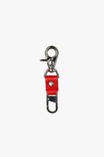 Red leather key clip with swivel clasp and loop attachment on a light background