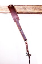 Dark brown leather strap close-up showing rivets and adjustment details of the Garioch single camera strap.