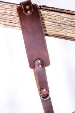 Close-up of the dark brown leather strap end and stitching on the Garioch single camera strap.