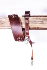 Dark brown leather shoulder pad and strap hardware detail of the Garioch single camera strap.