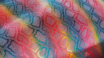 Extreme close-up macro detail of the rainbow multicolor leather texture, showing the mosaic snakeskin-embossed pattern with vibrant pink, blue, turquoise, yellow, green, red, and purple tones blending across the surface.