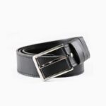 Black leather belt with silver buckle on white background