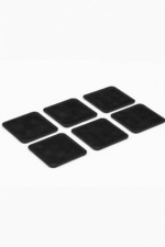 Set of six black leather coasters with stitched edges arranged on a light gray background.
