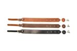 Three premium leather camera hand straps in tan, brown, and black laid flat, showing adjustment holes and rivets.
