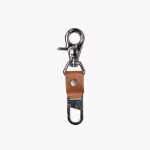 Leather Tow Anchor Vintage attached to a camera strap for keeping the camera close to the body, lifestyle close-up