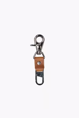 Leather Tow Anchor Vintage attached to a camera strap for keeping the camera close to the body, lifestyle close-up