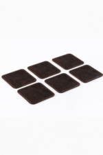 Set of six dark brown leather coasters with stitched edges arranged on a light gray background.