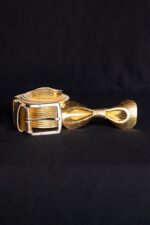 Gold padded leather trouser belt with silver buckle, keeper loop and stitched edges on white background