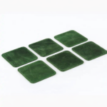 Set of six green leather coasters with stitched edges arranged on a light gray background.