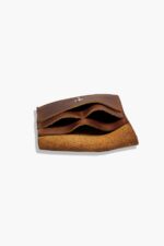 Angled side view of the leather battery holder showing multiple internal compartments