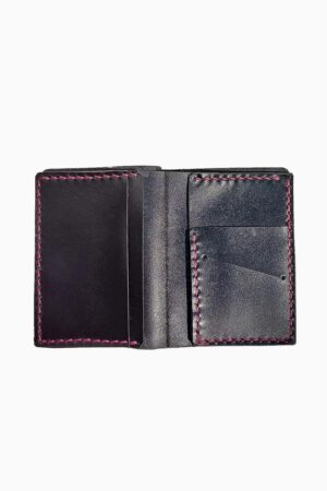 Interior view of a black leather bifold wallet opened flat and empty, showing two card pockets on the left side and two angled card slots on the right side, all finished with fuchsia pink hand-stitching, against a white background.