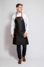 Classic leather apron in vintage brown – front view showing neck patch and buckle detail