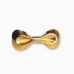 Gold metallic leather bow tie with a herringbone texture pattern on a white background, showcasing the sculpted butterfly shape and reflective finish.