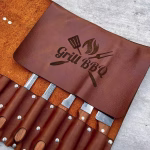 Close-up of leather knife holder 7s slots and buckle detail