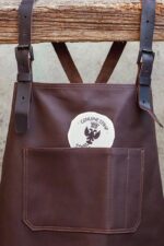 Leather apron chest pocket on model – full length view showing two front pockets