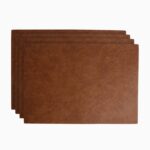 Set of four tan brown leather placemats fanned out in a staggered stack on a white background, showing the natural grain texture of the leather.