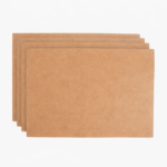 Stack of light brown leather card sleeves on a light background.