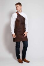One strap leather apron worn by man – showing shoulder strap and full length