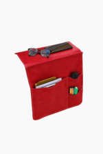Red leather wall pocket organizer holding glasses, mail, and small accessories on a light background.