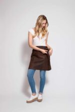 Short suede leather apron with back pocket – worn by woman, front view