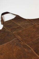 Suede leather apron worn by man – full front view showing neck strap and hip ties