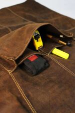 Suede leather apron worn by man – side view showing front pocket and leather texture