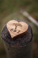 Wood Ring Box open at angle showing two ring slots lined with natural green moss