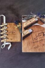 Wooden USB drive lying across dried lavender stems on top of a printed card