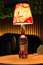 Handcrafted Aperol bottle lamp – lit up warm orange glow