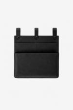 Black leather wall pocket organizer with three hanging tabs on a light background.