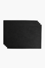 Stack of black leather card sleeves on a light background.