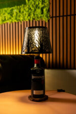 Handcrafted Brockmans bottle lamp – lit up with black shade