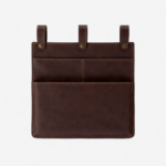 Dark brown leather wall pocket organizer with three hanging tabs on a light background