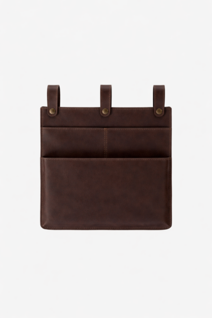 Dark brown leather wall pocket organizer with three hanging tabs on a light background